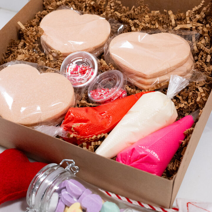 Valentine cookie kit box with heart-shaped sugar cookies, frosting bags and sprinkles