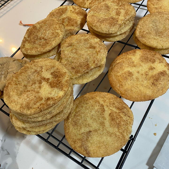 Cinnamon sugar snickerdoodle cookies stacked on a cooling rack